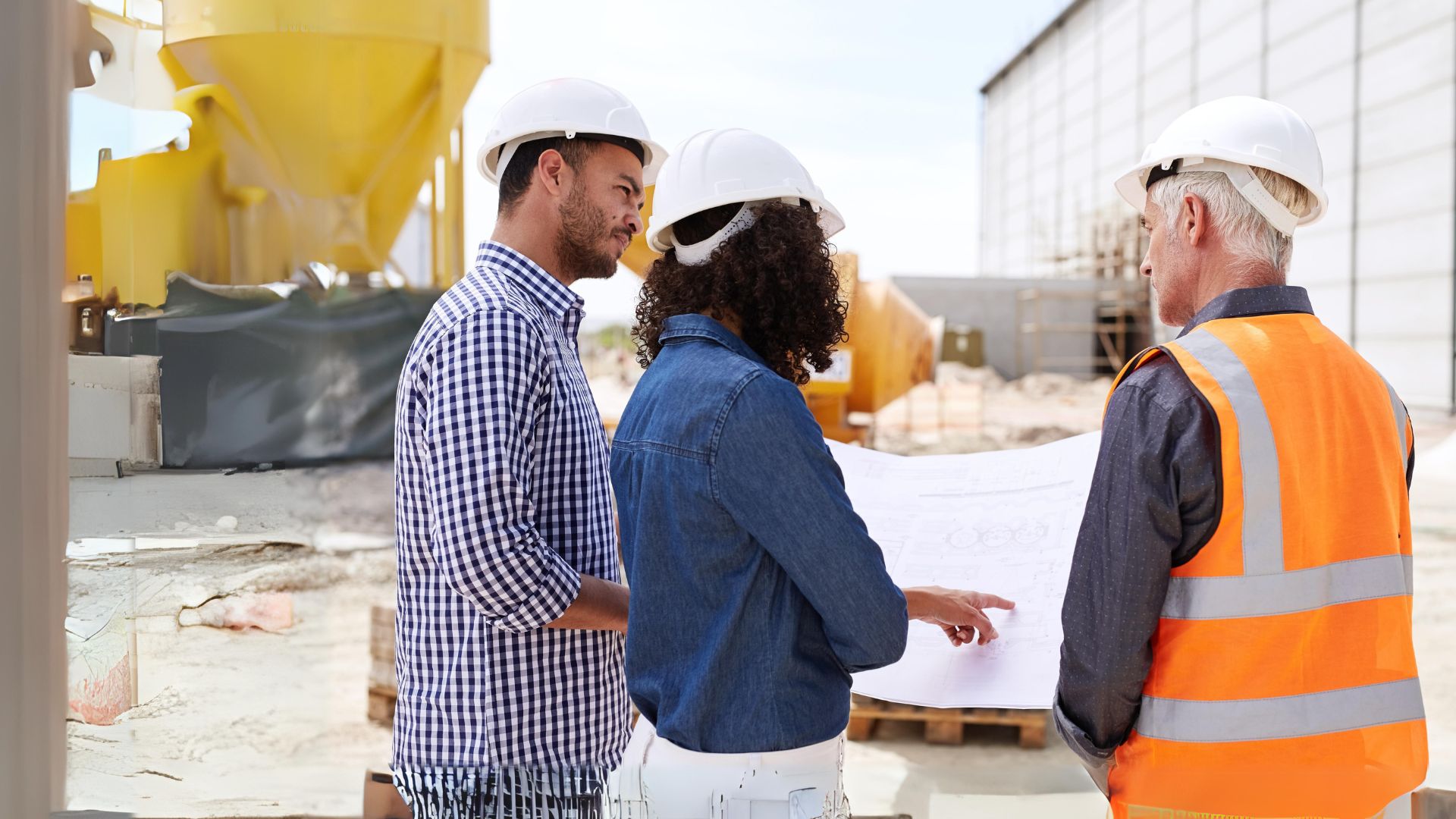 Construction workers discussing work on site